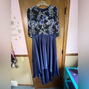 Never worn. Longer in the back, past knee length in front. Satin bottom.